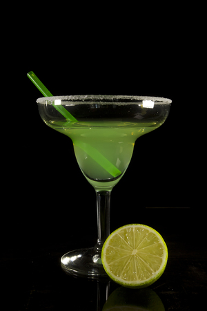 Classic Margarita Cocktail on a Black Reflective Surfaceの写真素材