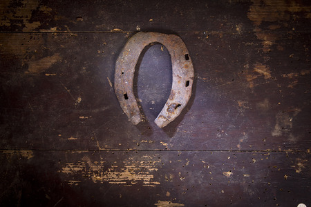 Old rusty horseshoe on a wooden backgroundの写真素材