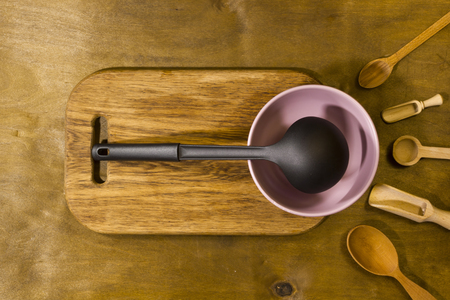 Varied cooking utensils on a wooden tableの写真素材