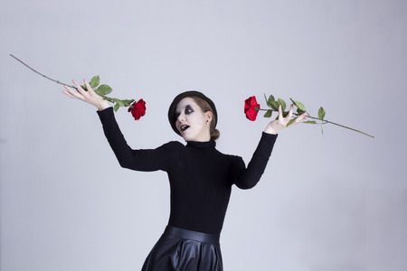 Mime girl with red roses on a gray backgroundの写真素材