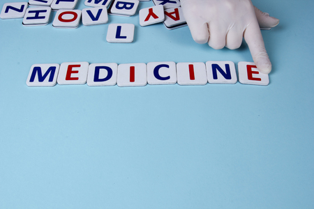 Writing words from cardboard letters on a blue backgroundの写真素材
