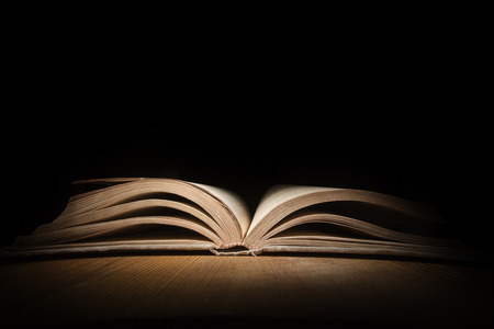 Old open book on a wooden tableの写真素材