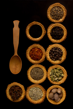 Tartlets with spices on a black backgroundの写真素材