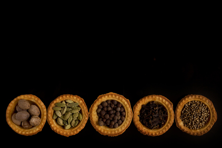 Tartlets with spices on a black backgroundの写真素材