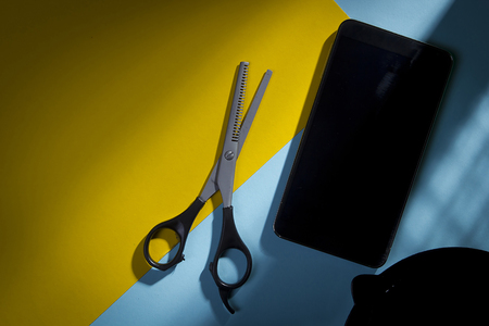 Tools hair stylist on a blue-yellow backgroundの写真素材