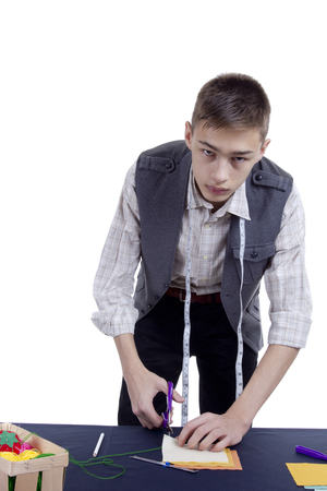 Young man tailor on white isolated backgroundの写真素材