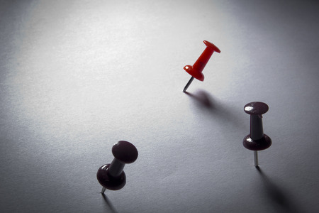 Pins stuck into a blank sheet of paper.の写真素材