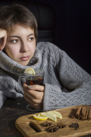 Young woman in a sweater with a hot drinkの写真素材