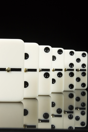 Stacks of Dominoes on a black reflective surface