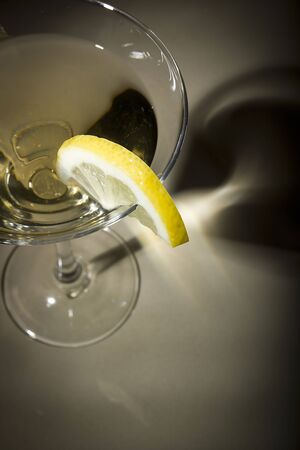 A glass of daiquiri and lemon casts a shadowの写真素材