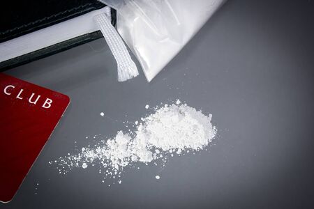 Drug cocaine in a bag and poured on a tableの写真素材