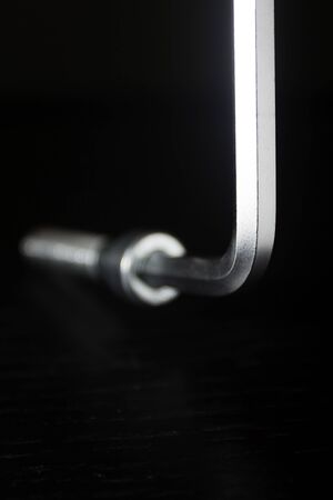 New machine bolt and hex screwdriver on black backgroundの写真素材