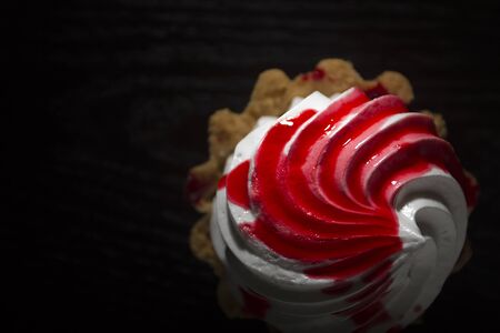 Cake Basket with cream and jam on a black backgroundの写真素材