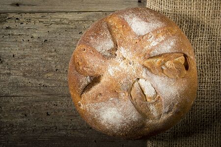 Loaf of bread on a table of old wood