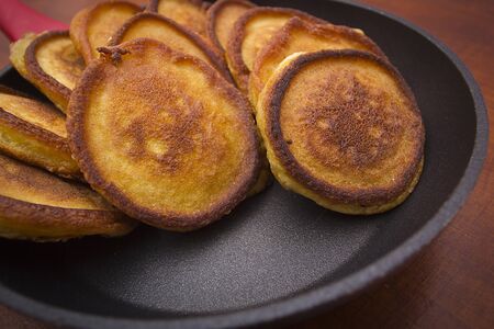 Fritters in a pan on a wooden tableの写真素材