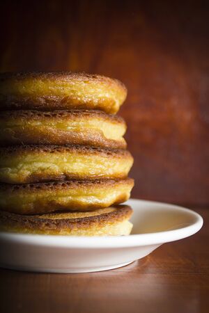 Fresh hot pancakes on a white ceramic plate