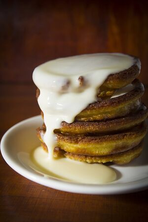 Fresh hot pancakes on a white ceramic plate