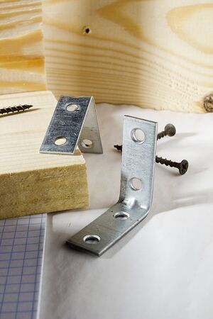 Metal corners and screws for fixing wooden boards