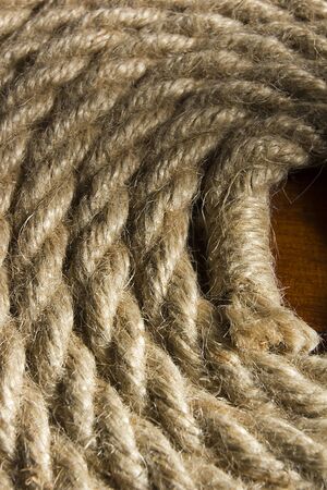 Neatly rolled sea rope on a wooden table