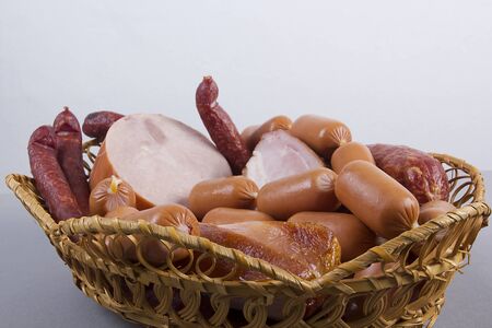 Set of various sausages in a wicker basket