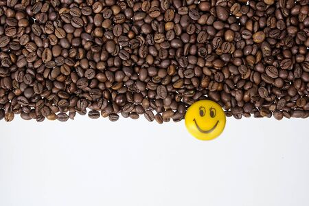 Coffee beans on a white table as a backgroundの写真素材
