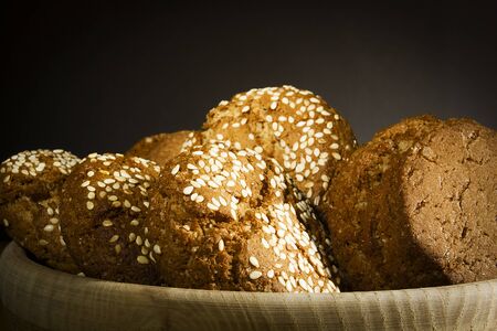 Crispy oatmeal cookies on a black background