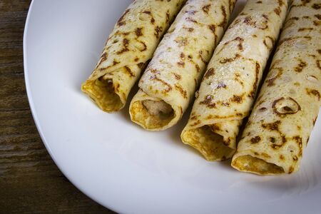 Pancakes with sweet cream on a white plateの写真素材