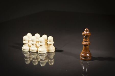 Chess pieces on a black reflective surface