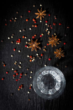 Anise vodka in a glass on a wooden surfaceの写真素材