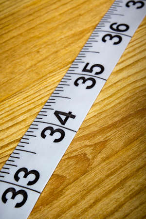 White tailor meter on a wooden table