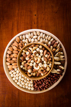 Set of various nuts in a wooden bowlの写真素材