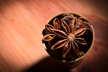 Anis in bowl, dark background, selective focusの写真素材