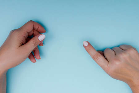 Female hands gestures on a blue background