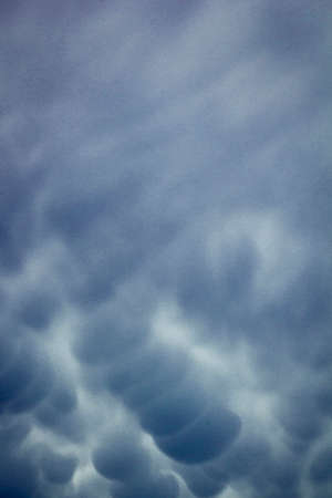 Menacing mammatus clouds before the storm, stormy sky, climate change and unpredictable terrifying...