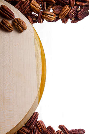 Cutting board and nuts on white background