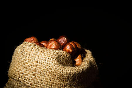 Unpeeled hazelnuts in a bag close up
