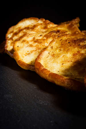 Fresh pancakes with corn on a wooden board