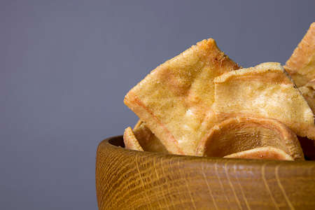 Chips in a wooden plate close up