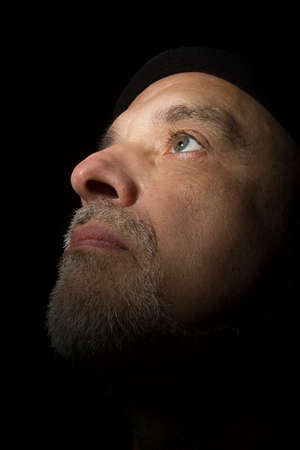 Portrait of a man with a gray beard on a black backgroundの写真素材