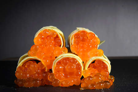 Pancakes with red caviar close-up on a gray backgroundの写真素材