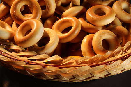 Basket with ring-shaped cookies close-up as backgroundの写真素材