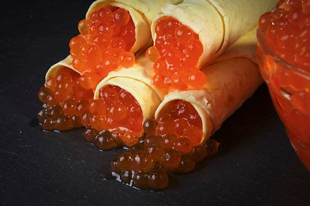 Pancakes with red caviar close-up on a gray backgroundの写真素材