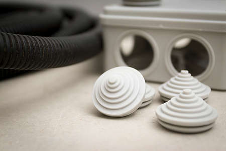 White plastic electrical junction box and black braided wires