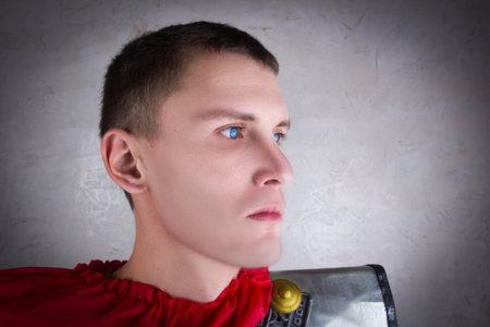 Portrait of a Roman legionary posing against a gray wallの写真素材