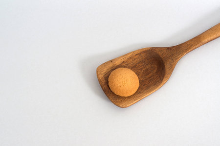 Plain butter cookies on wooden ladle , white background.の写真素材