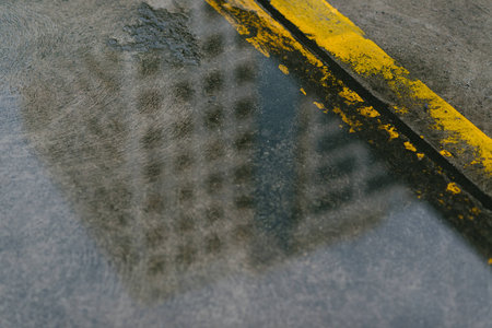 Yellow traffic line on wet roadの写真素材