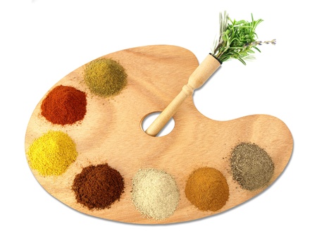 Herbs and spices on a wooden paletteの写真素材