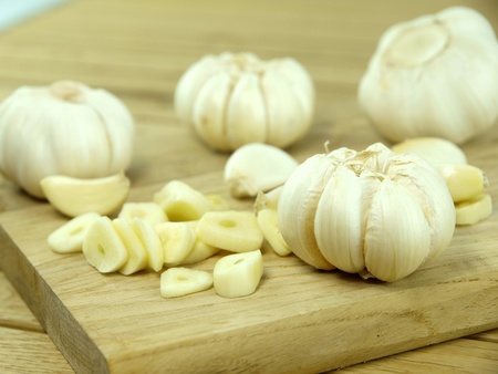 Garlic pods over wooden tableの写真素材