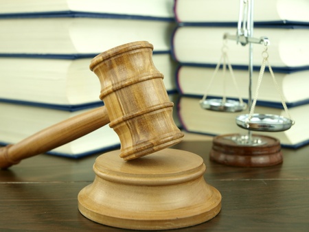Judges Gavel and scale of justice with a stack of legal books backgroundの写真素材