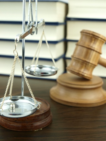 Judges Gavel and scale of justice with a stack of legal books backgroundの写真素材